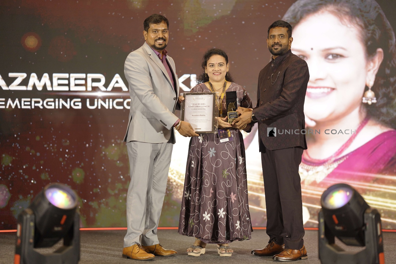 Rekha receiving the Emerging Unicorn Coach trophy and certificate presented by Binge Marketing
