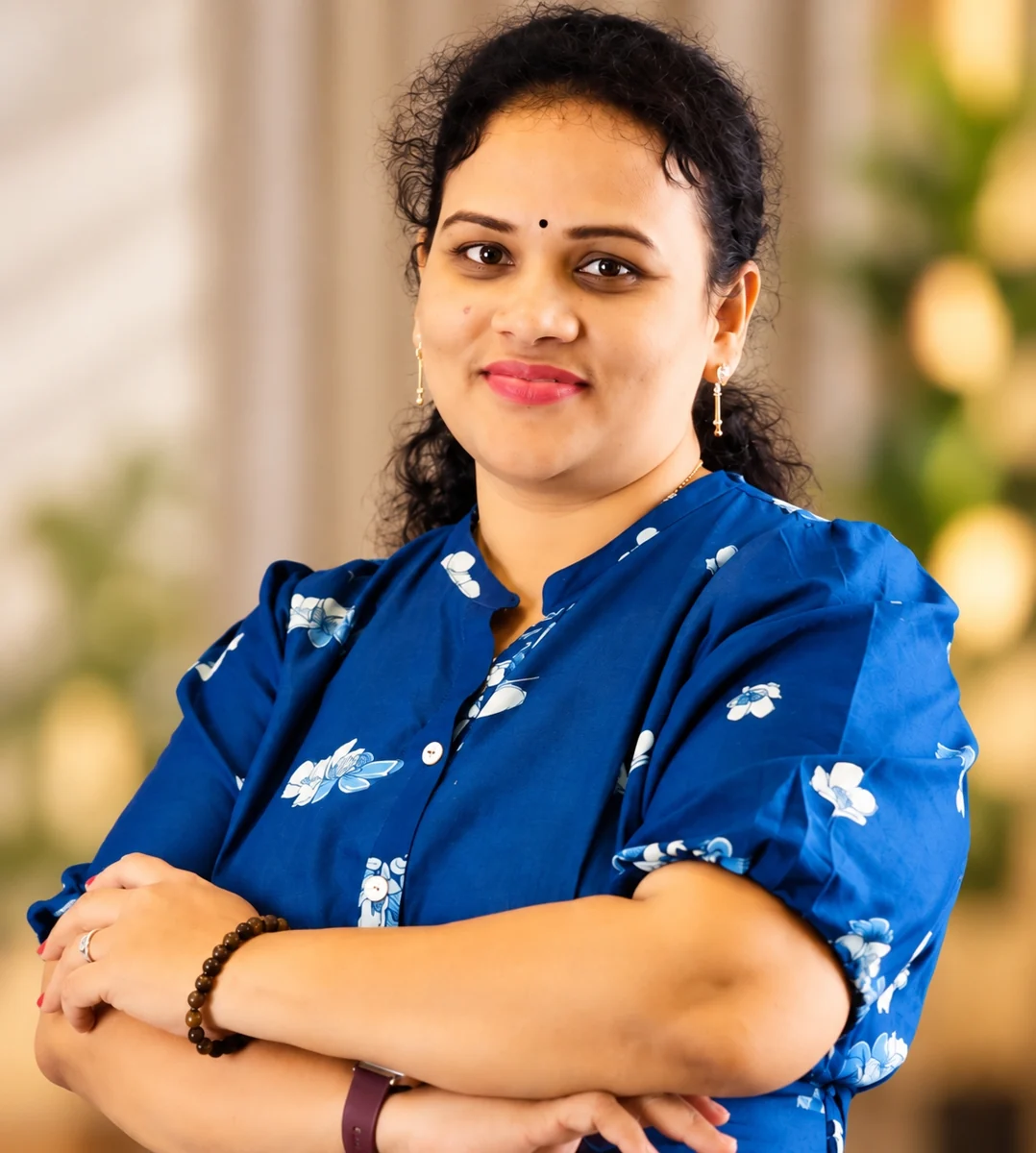 Rekha smiling in her royal-blue outfit